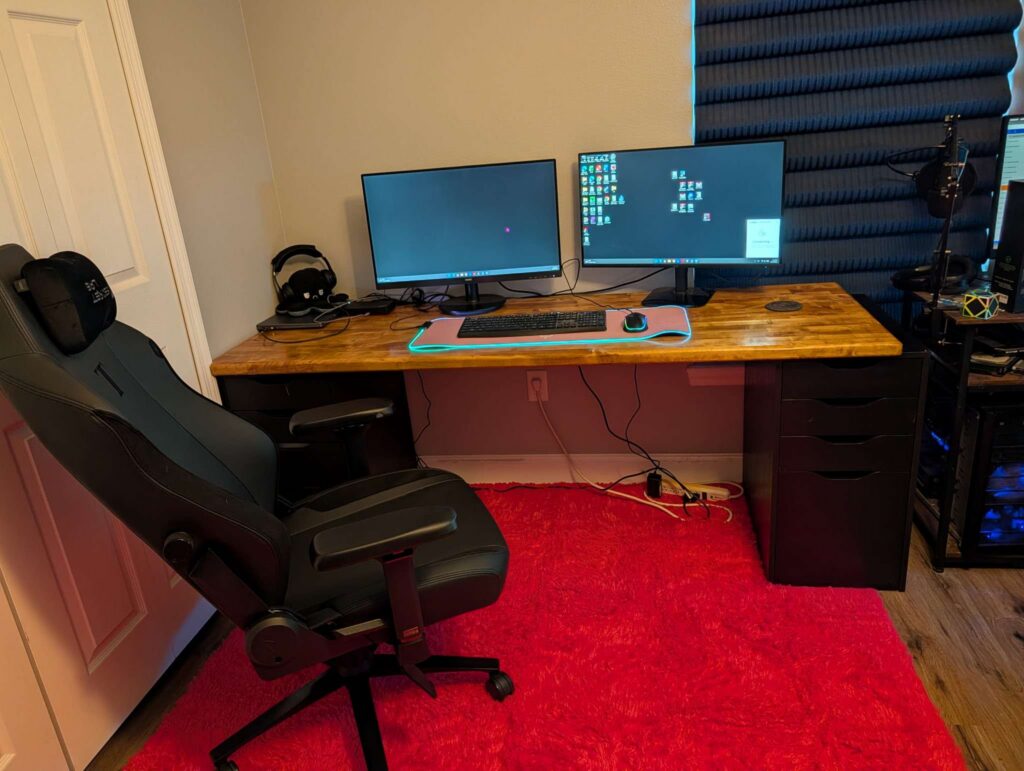 Completed six-foot birch butcher-block desk with dual monitors and black drawer bases