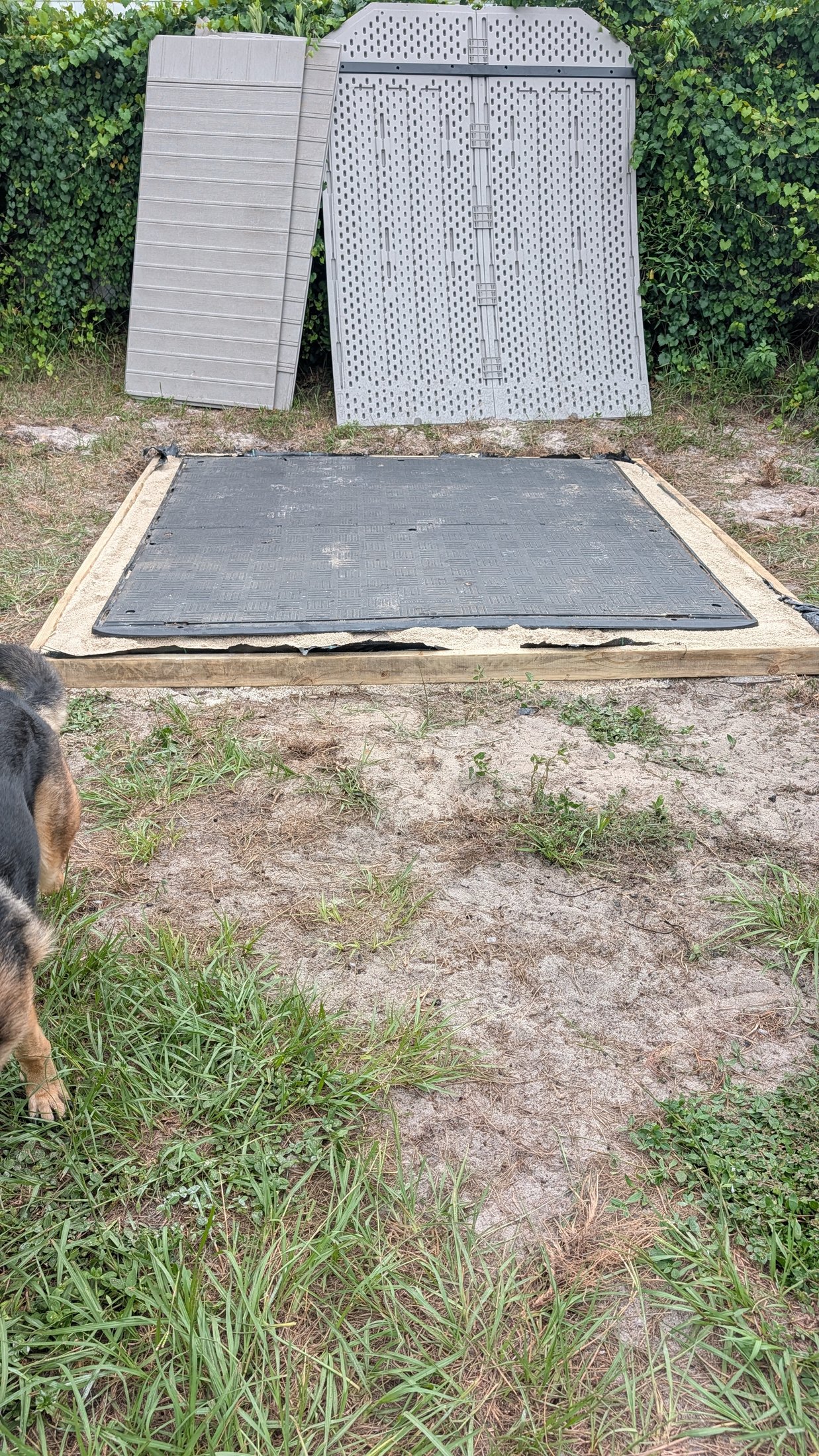 The shed's rubber floor seated evenly on the prepared foundation