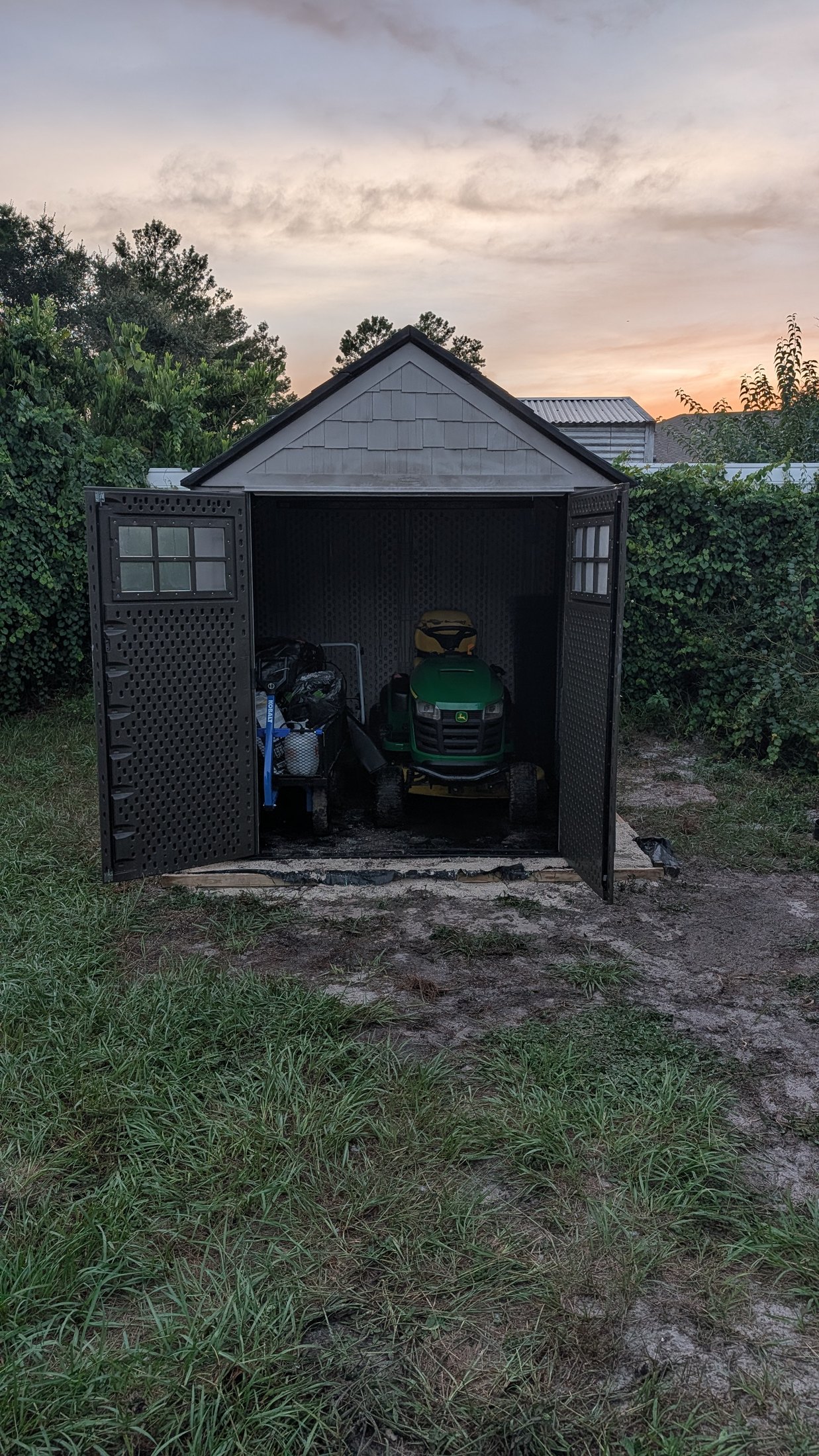 The finished shed with a riding mower filling most of the available space